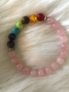 Isn’t our 7 Chakra Rose Quartz Crystal bracelet beautiful? 😍 This unique bracelet represents the seven chakras that centers our bodies in which our energy flows through. Each spiritual colored stone corresponds to a specific chakra to bring healing, balance, and raise vibrations. The 7 Chakra crystals are: 💎 Amethyst (crown chakra) 💎 Lapis Lazuli (third eye) 💎 Turquoise (throat chakra) 💎 Aventurine (heart chakra) 💎 Tiger Eye (solar plexus chakra) 💎 Carnelian (sacral chakra) 💎 Red Jasper Beaded Bracelet Diy, Chakra Beads Bracelet, Girly Bracelets, Setting Intentions, Intention Bracelets, Healing Gemstone Bracelets, Chakra Beads, Seven Chakras, Bracelet Love