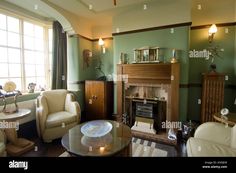 a living room filled with furniture and a fire place in front of a large window