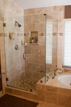 a bathroom with a walk in shower next to a bath tub