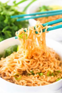 a bowl of peanut butter ramen with chopsticks sticking out of the noodles