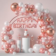 a pink and white birthday party with balloons