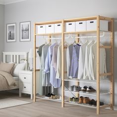 a bedroom with a bed, dresser and clothes rack