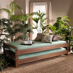 a living room filled with lots of green plants