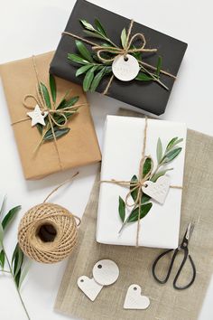 three wrapped presents tied up with twine and twine on top of each other