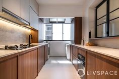 a narrow kitchen with wooden cabinets and white counter tops