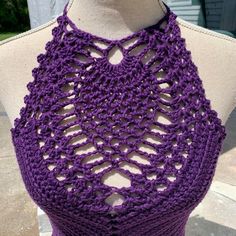 a purple crocheted halter top on a mannequin