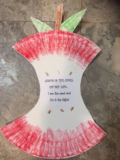 an apple shaped paper plate with a quote on it