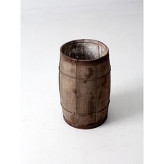 a wooden barrel sitting on top of a white table