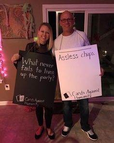 two people holding up signs that say what never falls to liven up the party