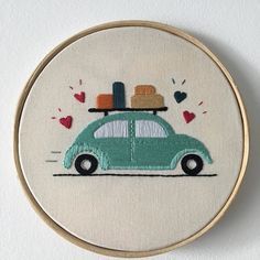 a small cross stitch car with luggage on top