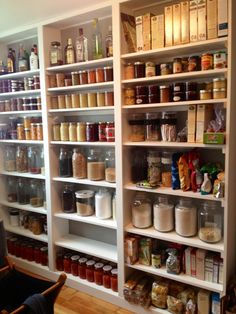 a large pantry filled with lots of different types of food and condiments on shelves