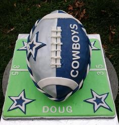 a cake made to look like a football on top of a green and white field