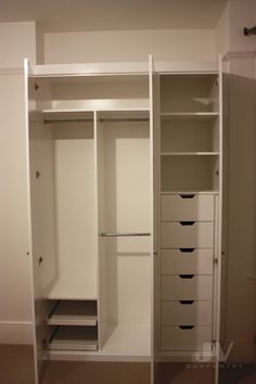 an empty white closet with drawers and shelves