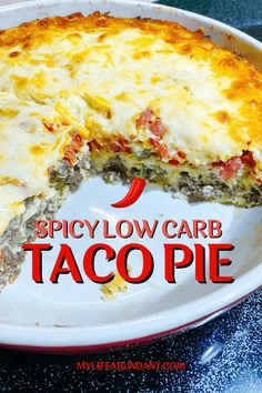 a close up of a pizza on a plate with the words spicy low carb taco pie