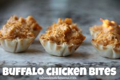 three small cups filled with food sitting on top of a counter next to the words buffalo chicken bites