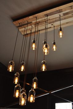 a chandelier made out of mason jars hanging from the ceiling