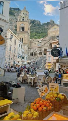 an outdoor market with lots of fruit on display