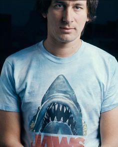 a man wearing a jaws t - shirt with a shark's teeth on it