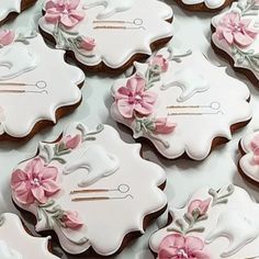 decorated cookies with pink flowers and scissors on them