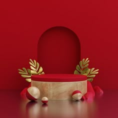 a red and gold object is sitting on the floor next to other objects in front of a red wall