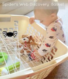 a baby playing with toys in a basket