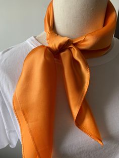 Luxurious solid color pure mulberry silk square scarf, Orange, Size: 65 cm x 65 cm / 26 in x 26 in. Soft, smooth, and lustrous silk charmeuse fabric, breathable and skin-friendly feels very soft and comfortable to wear. Can style in many ways: you can wear this scarf as a soft neck scarf, as a hair tie, as a head band scarf, as a wrist scarf, as a purse accessory scarf. Or style it in any way you want with your own sense of creativity! Suitable for all seasons and is a great gift idea for specia Silk Scarves Perfect For Gifts, Solid Color Silk Scarf For Formal Summer Occasions, Orange Silk Scarf For Summer Gift, Satin Silk Scarf Gift, Solid Silk Scarf Gift, Elegant Orange Silk Scarf For Gift, Elegant Orange Silk Scarf As Gift, Elegant Orange Silk Scarf, Elegant Orange Summer Scarf