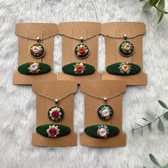 six different necklaces with flowers on them