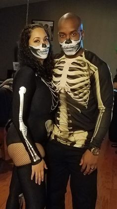 a man and woman dressed up in skeleton costumes