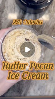 a person holding a container with ice cream in it and the words, butter pecan ice cream