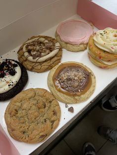 a box filled with lots of different types of cookies