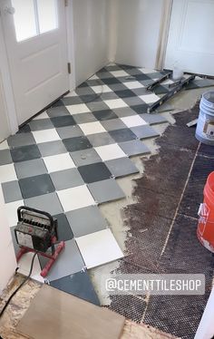 a room that is being remodeled with tile on the floor and tools in front of it