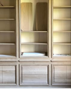 an empty bookcase in the corner of a room