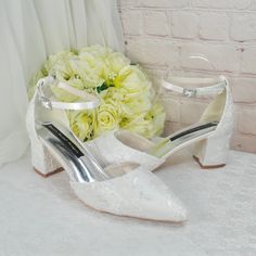 a pair of white shoes with flowers in the background