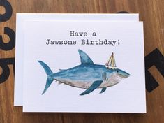 a birthday card with a shark wearing a party hat and the words have a jawome birthday written on it