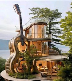 an unusual house with a guitar on the roof and stairs leading up to it's second floor