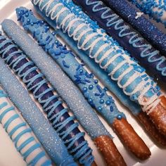 blue and white donuts are lined up on a plate