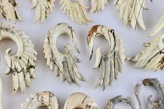 several pieces of white and brown wood that have been carved to look like wings