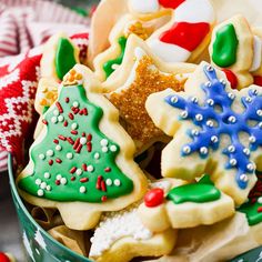 a bowl filled with christmas cookies on top of a table