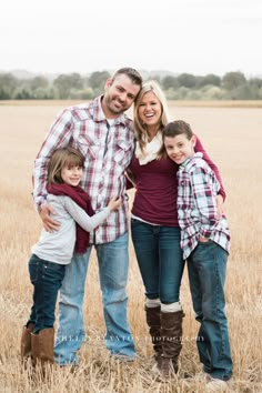 a family posing for a photo in a field