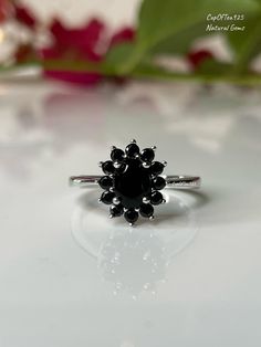 a black diamond ring sitting on top of a table