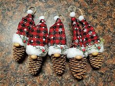 three pine cones with christmas decorations on them