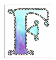 the letter f is painted in blue, purple and green with an ornate border around it