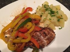 a white plate topped with meat and veggies