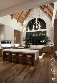 a large kitchen with wooden floors and white counter tops