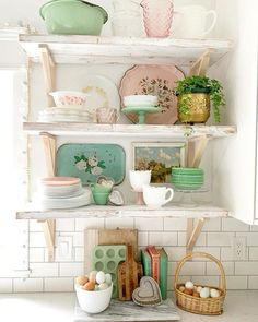 the shelves are filled with dishes and other items in pastel colors, such as eggs