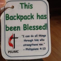 a person holding up a white tag that says, this backpack has been blessed i can do all things through him who straightens me