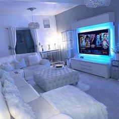 a living room filled with white furniture and a flat screen tv