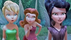 three animated fairy girls standing next to each other in front of trees and grass, with one looking surprised at the camera