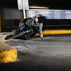 a man sitting on the ground next to a motorcycle