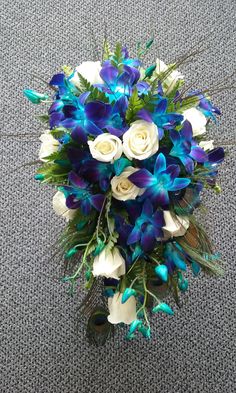 a bridal bouquet with blue and white flowers on the floor in an office building